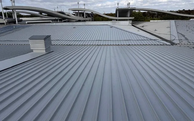 Liquid-waterproofed profiled retail roof with a ventilation cowl in Greenford